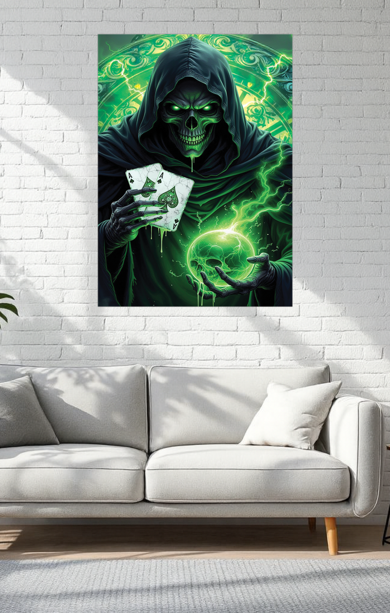 Poster of a green-skinned figure in a hood holding playing cards on a white brick wall above a gray sofa.