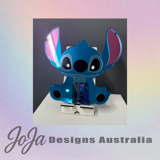 Blue character with pink accents on a stand against a gradient background, branded 'JoJa Designs Australia'.